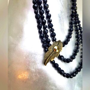 Gorgeous 20s Era style necklace black faceted glass beads& brass/gold tone leaf